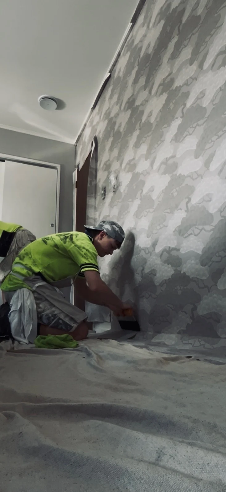 Painter carefully preparing an interior wall