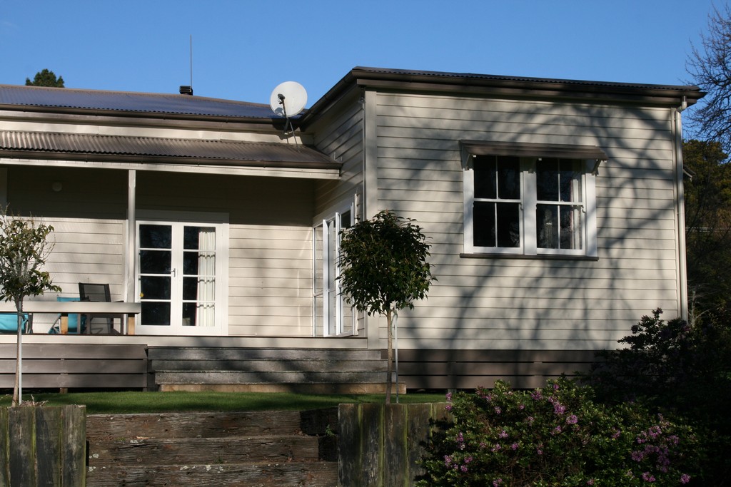 landscape exterior of a dark grey modern home